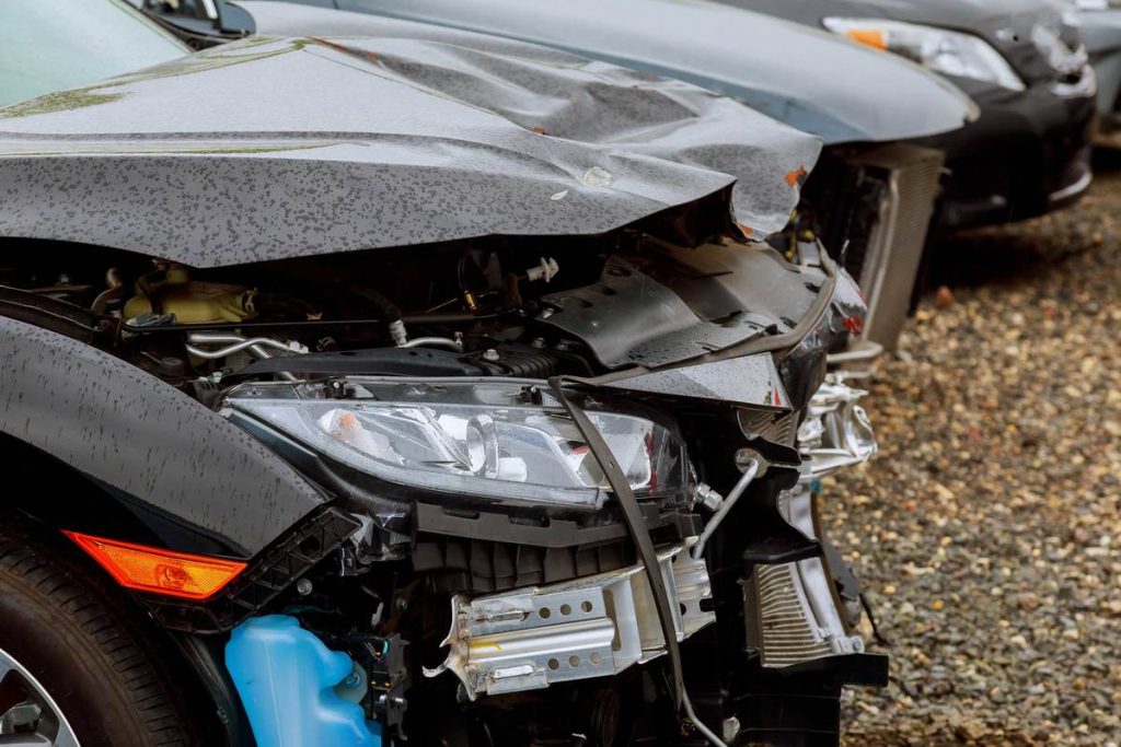 smashed front end of a car that is needing panel beating services