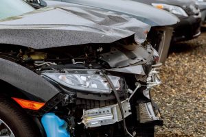 smashed front end of a car that is needing panel beating services